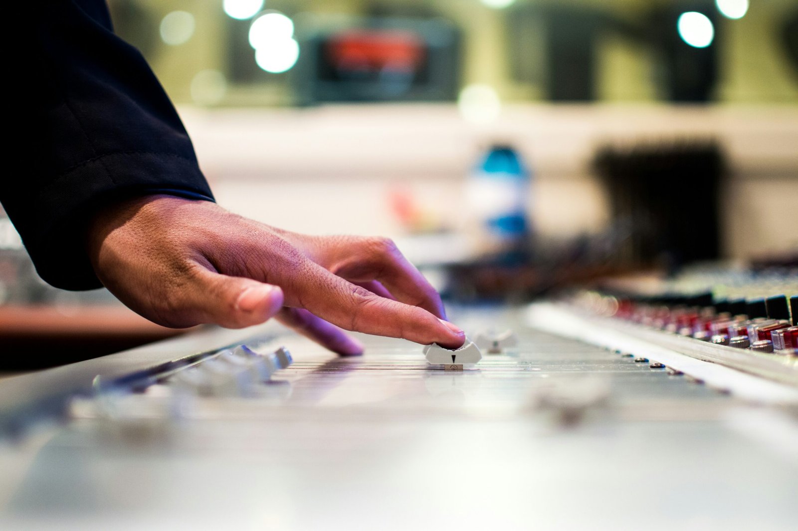 person holding mixing console person holding mixing console